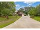 Home exterior with a long driveway, lush lawn, and an outdoor shed on a sunny day at 127 Pinfeather Trail, Myrtle Beach, SC 29588