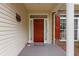 Charming front porch with a red door, neutral siding, and decorative accents, creating an inviting entry at 127 Pinfeather Trail, Myrtle Beach, SC 29588