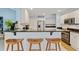 Open-concept kitchen featuring a breakfast bar with wooden stools, granite counters, and stainless steel appliances at 127 Pinfeather Trail, Myrtle Beach, SC 29588