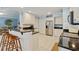 Bright kitchen with white cabinets, granite countertops, tile flooring, and stainless steel appliances at 127 Pinfeather Trail, Myrtle Beach, SC 29588