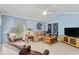 Cozy living room featuring comfortable seating, a ceiling fan, and built-in shelving for storage and display at 127 Pinfeather Trail, Myrtle Beach, SC 29588