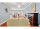 Open living room with fireplace, hardwood floors, ceiling fan, and views of the dining area and front door at 127 Pinfeather Trail, Myrtle Beach, SC 29588