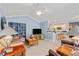 Spacious living room open to the kitchen area, featuring a ceiling fan and comfortable seating at 127 Pinfeather Trail, Myrtle Beach, SC 29588