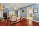 Inviting living room featuring hardwood floors, blue walls, and comfortable seating for relaxation at 127 Pinfeather Trail, Myrtle Beach, SC 29588