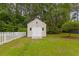 Outdoor storage shed with double door and white picket fence at 127 Pinfeather Trail, Myrtle Beach, SC 29588