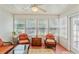 Bright sunroom featuring wicker furniture, terra cotta tile flooring, and multiple windows for natural light at 127 Pinfeather Trail, Myrtle Beach, SC 29588