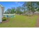Expansive backyard with a well-manicured lawn, inviting patio, and mature trees at 1307 Collins Park St., Conway, SC 29526
