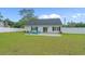 Charming backyard with a patio, Adirondack chairs, a fire pit, and lush green lawn at 1307 Collins Park St., Conway, SC 29526