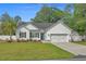 Charming single-story home featuring a manicured lawn, two-car garage, and inviting curb appeal at 1307 Collins Park St., Conway, SC 29526