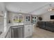 Open kitchen featuring granite countertops with stainless steel dishwasher and view of the living room at 1307 Collins Park St., Conway, SC 29526