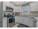 Modern kitchen featuring stainless steel appliances and white cabinets at 1307 Collins Park St., Conway, SC 29526