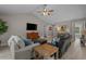Comfortable living room featuring modern flooring, an entertainment center, and cozy seating arrangement at 1307 Collins Park St., Conway, SC 29526