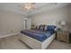 Comfortable main bedroom featuring a tray ceiling, ample lighting and view of the ensuite at 1307 Collins Park St., Conway, SC 29526
