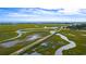 Expansive view featuring a long bridge crossing a marsh leading to a golf course and the ocean at 141-4 Weehawka Way # 4, Pawleys Island, SC 29585