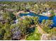 Stunning aerial view of a lakeside community with a pool, lush greenery, and beautiful homes at 141-4 Weehawka Way # 4, Pawleys Island, SC 29585