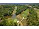 Scenic aerial view of a golf course with lush fairways, ponds, and a charming bridge at 141-4 Weehawka Way # 4, Pawleys Island, SC 29585