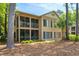 The back of the home features a screened-in porch on both levels and is surrounded by mature trees at 141-4 Weehawka Way # 4, Pawleys Island, SC 29585