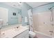 This is a bathroom with a shower-tub combo, toilet, and vanity with mirror and accent wall at 141-4 Weehawka Way # 4, Pawleys Island, SC 29585