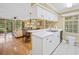 Bright kitchen with white cabinets, stainless steel sink, and breakfast bar open to the living and dining areas at 141-4 Weehawka Way # 4, Pawleys Island, SC 29585