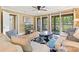 Comfortable living room with neutral tones, a ceiling fan, and access to the deck with views of the golf course at 141-4 Weehawka Way # 4, Pawleys Island, SC 29585