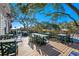 Spacious outdoor dining area with comfortable seating and a beautiful view under the trees at 141-4 Weehawka Way # 4, Pawleys Island, SC 29585