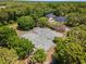 Aerial view of well-maintained tennis courts surrounded by lush greenery and beautiful homes at 141-4 Weehawka Way # 4, Pawleys Island, SC 29585