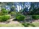 Well-maintained backyard with lush greenery, landscaping, and brick border at 152 Gateway Dr., Little River, SC 29566