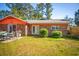 Brick house backyard featuring a lawn, patio, and sliding glass doors at 152 Gateway Dr., Little River, SC 29566