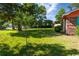 Large, grassy backyard with mature trees and landscaping, ideal for outdoor activities at 152 Gateway Dr., Little River, SC 29566