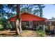 Rear exterior of a brick home featuring a covered patio and a large yard at 152 Gateway Dr., Little River, SC 29566