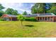 Single-story house with solar panels, a spacious lawn, and a brick exterior at 152 Gateway Dr., Little River, SC 29566