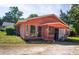 Exterior view of house with a screened in porch and grassy yard at 152 Gateway Dr., Little River, SC 29566