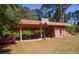 Carport featuring a basketball hoop and storage for tools and equipment at 152 Gateway Dr., Little River, SC 29566