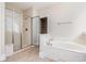 Well-lit bathroom features a glass shower and a soaking tub at 1549 Kensington Ln., Myrtle Beach, SC 29577