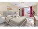 Bedroom features a large window, a ceiling fan, and neutral walls, creating a serene atmosphere at 1549 Kensington Ln., Myrtle Beach, SC 29577