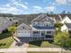 Charming two-story home showcasing a well-manicured lawn, inviting front porch, and attached two-car garage at 1549 Kensington Ln., Myrtle Beach, SC 29577