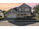 Attractive house featuring a quaint front porch, neutral color palette, and manicured landscaping at 1549 Kensington Ln., Myrtle Beach, SC 29577