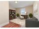 This office space features a large bookshelf, stylish furniture, and plenty of natural light from a window at 1549 Kensington Ln., Myrtle Beach, SC 29577