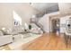 Spacious living room featuring hardwood floors, high ceilings, an open staircase, and a neutral color palette at 1549 Kensington Ln., Myrtle Beach, SC 29577
