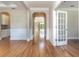 Spacious living area featuring hardwood floors, wainscoting, and arched doorways at 1549 Kensington Ln., Myrtle Beach, SC 29577