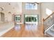Bright living room with high ceilings, large windows, and hardwood floors at 1549 Kensington Ln., Myrtle Beach, SC 29577
