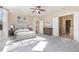 Spacious primary bedroom features a ceiling fan, a plush bed, and an ensuite bathroom at 1549 Kensington Ln., Myrtle Beach, SC 29577