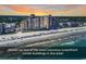 Luxurious oceanfront condo building on a sandy beach with ocean views and a beautiful sunset at 1620 N Waccamaw Dr. # 103, Garden City Beach, SC 29576