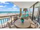 Charming balcony with a table and chairs, perfect for ocean views at 1620 N Waccamaw Dr. # 103, Garden City Beach, SC 29576