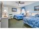 Inviting bedroom features two beds, soft blue walls, a ceiling fan and stylish decor at 1620 N Waccamaw Dr. # 103, Garden City Beach, SC 29576