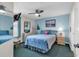 Comfortable bedroom with soft blue walls, a ceiling fan and a full bed featuring a lovely headboard at 1620 N Waccamaw Dr. # 103, Garden City Beach, SC 29576