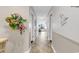 Bright hallway with decorative flower arrangement and ocean view at the end of the hall at 1620 N Waccamaw Dr. # 103, Garden City Beach, SC 29576