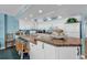 Bright kitchen with bar seating, white cabinets, and ocean themed decorations at 1620 N Waccamaw Dr. # 103, Garden City Beach, SC 29576