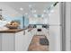 Bright kitchen with white cabinets, stainless steel appliances, and a tile floor at 1620 N Waccamaw Dr. # 103, Garden City Beach, SC 29576
