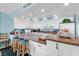Bright kitchen with bar seating, white cabinets, and ocean themed decorations at 1620 N Waccamaw Dr. # 103, Garden City Beach, SC 29576